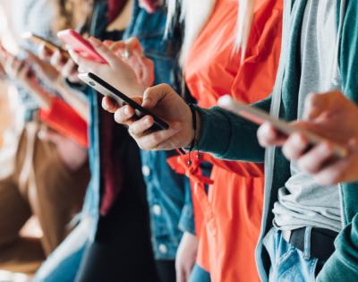 many hands holding phones