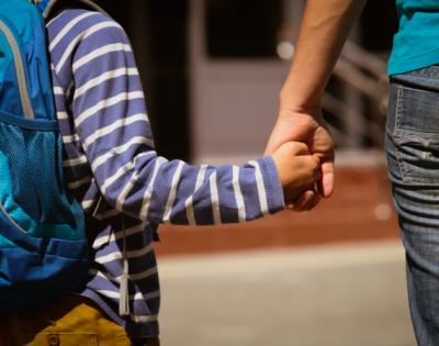 Mom holds her son's hand