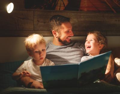 Dad reading a bedtime story to children before bed